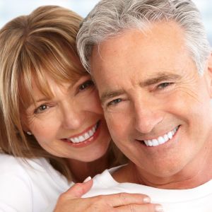 Middle age couple smiling denture treatment