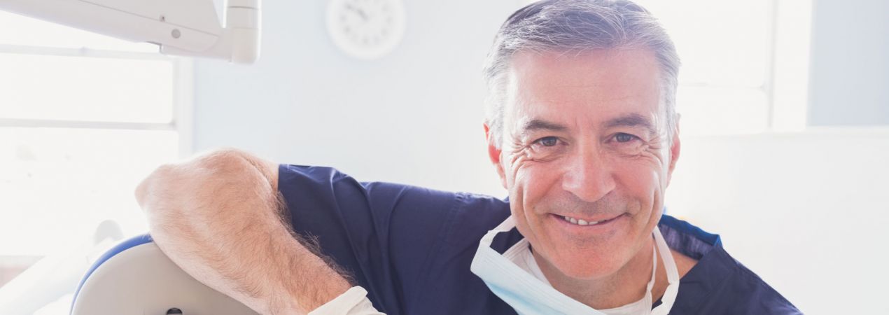 Dentist smiling Oral Health is Our Passion